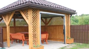 a pavilion with a table and chairs on a patio at Domek Pod Różą in Krasnobród +2 photos