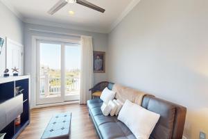 uma sala de estar com um sofá de couro e uma janela em Cosmo's Cabana em North Topsail Beach