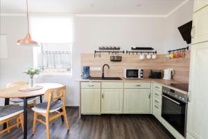 a small kitchen with a table and a sink at Ferienwohnung Alter Bahnhof in Kröslin