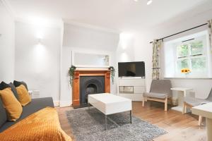 a living room with a couch and a fireplace at Al's Kingsdown Parade F1 in Bristol