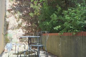 two chairs and a table in front of a wall at Al's Kingsdown Parade F1 in Bristol