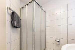 a shower with a glass door in a bathroom at Ferienwohnung Rheinblick in Küssaberg