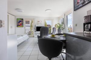 a kitchen and living room with a table and chairs at Ferienwohnung Rheinblick in Küssaberg +11 photos