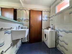 a bathroom with a sink and a washing machine at Appartamento Tosca in Verona +20 photos