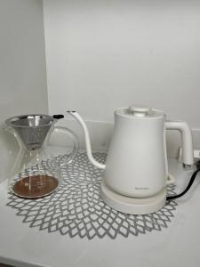 a coffee maker and a blender on a counter at Platina Luxe House in Toyama