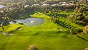 an overhead view of a golf course with a pond at Kaya Belek in Belek