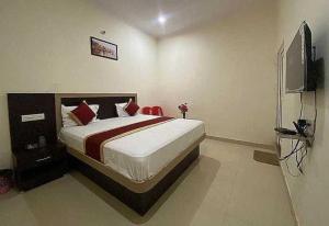 a bedroom with a bed and a television in it at Hotel Nath Palace Chunar Road Varanasi - Luxury Room - Excellent Service Recommended in Varanasi