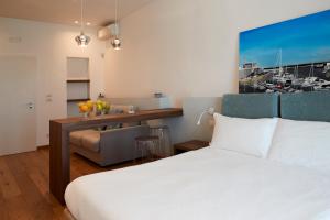 a bedroom with a bed and a desk with a sink at B&B Suite Home Trani in Trani