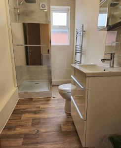 a bathroom with a toilet and a sink and a shower at Abbeydale Place-Spacious one bedroom flat in Heeley