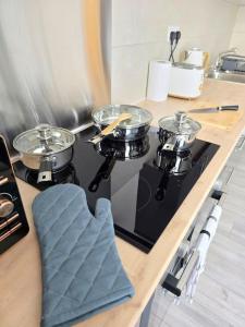 a kitchen with a stove with pots and pans on it at Abbeydale Place-Spacious one bedroom flat in Heeley