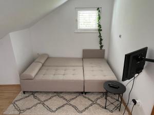 a small bedroom with a bed and a television at Apartman Kalac in Korčula