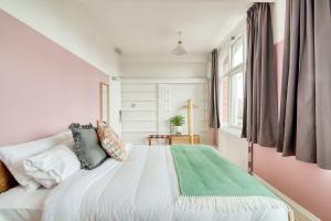 a bedroom with a white bed with a green rug on it at Malacuna Birmingham in Birmingham +31 photos