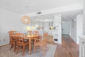 a kitchen and dining room with a table and chairs at Ground floor beachfront with steps to the beach and pool & beach access in New Smyrna Beach