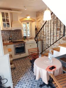 a kitchen with a table and a dining room at Sundial Stone House in Ždrelac +32 photos