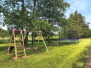 a park with two swings and a table at Kite Cottage in Llandeilo