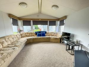 a large living room with a couch and a television at 6 Berth Caravan With Free Wi-fi At Dovercourt Holiday Park In Essex Ref 44009c in Great Oakley