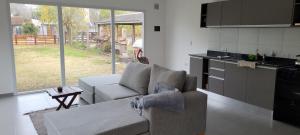 a living room with a couch and a kitchen at Lamerced in Mar de Cobo