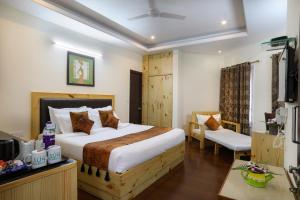 a hotel room with a bed and a tv at Hotel SunGrace in Mussoorie