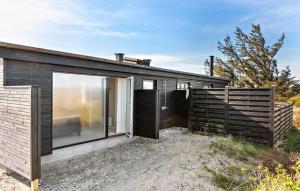 a small black house with a large glass door at 3 Bedroom Lovely Home In Saltum in Saltum +12 photos