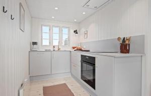 a white kitchen with white cabinets and an oven at 3 Bedroom Lovely Home In Saltum in Saltum