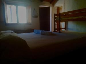 A bed or beds in a room at Case Rurali Pentedattilo