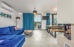 a living room with a blue couch and a table at Lovely Home In Kali With Wifi in Kali