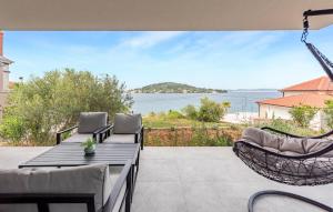 a patio with a hammock and a view of the water at Lovely Home In Kali With Wifi in Kali +20 photos