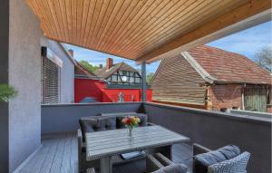 a patio with a wooden table and chairs on a balcony at Luxusvilla Mit Kegelbahn in Bahrdorf +40 photos