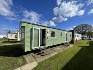a green tiny house parked in a yard at Great 8 Berth Caravan At Highfield Grange, Clacton-on-sea Ref 26214o in Clacton-on-Sea