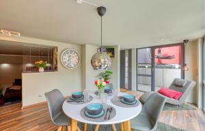 a dining room with a white table and chairs at Ferienwohnung In Luxusvilla in Bahrdorf