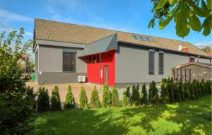 a house with a red door in a yard at Ferienwohnung In Luxusvilla in Bahrdorf