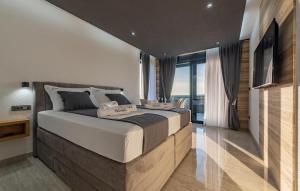 a bedroom with a large bed and a large window at 5 Bedroom Beautiful Home In Privlaka in Privlaka