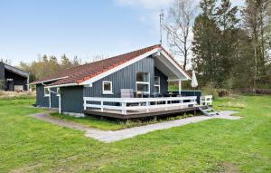 a small blue house with a large porch at Cozy Home In Silkeborg With Wifi in Silkeborg