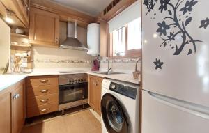 eine Küche mit einer Waschmaschine und einem Kühlschrank in der Unterkunft Stunning Home In Benicasim With Kitchen in Benicàssim