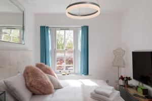 um quarto branco com uma cama e uma janela em Superb 1bed flat in Maida Vale em Londres