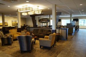 a lobby with couches and chairs and a waiting room at The Biltmore Hotel & Suites Main Avenue in Fargo