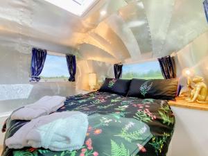 a bedroom with a bed in a tiny house at Lanes End Farm Airstream in Hawthorn