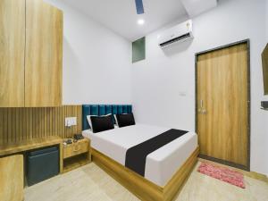 sypialnia z łóżkiem i drewnianymi drzwiami w obiekcie OYO HOTEL CASS INN w mieście Bhopal