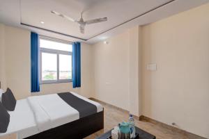 a bedroom with a bed and a window at OYO Samrat P Guest House in Jaipur