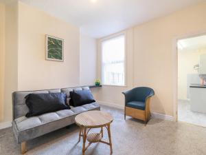 uma sala de estar com um sofá e uma cadeira em Lovely large 2-Bed House with 2 Reception Rooms em Atherstone