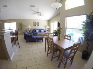 a living room with a table and a couch at Elite Homes - Eagle Pointe in Kissimmee