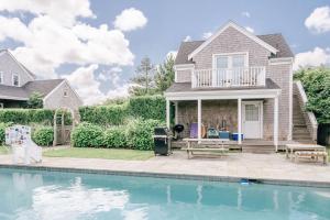 a house with a swimming pool in front of a house at Adorable guesthouse with stunning views close to beach in Nantucket