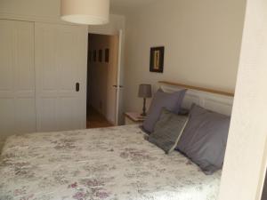 a bedroom with a large bed with purple pillows at Les Cyprès in La Cadiere d'Azur
