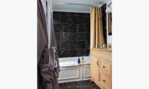 a bathroom with a sink and a shower with atains at Hideaway Inn Maine in Camden +102 photos