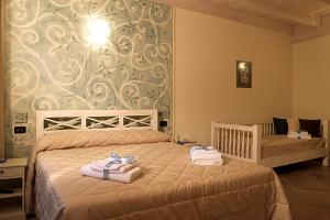 Postel nebo postele na pokoji v ubytování Agriturismo Il Barone