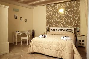 Postel nebo postele na pokoji v ubytování Agriturismo Il Barone