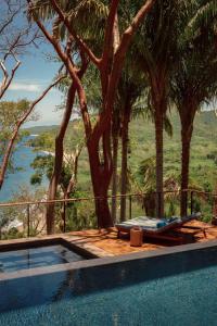a swimming pool with a view of a river and trees at One&Only Mandarina in Lo de Marcos