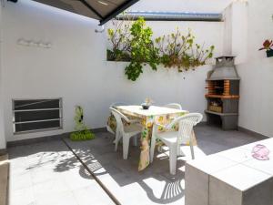une terrasse avec une table, des chaises et une cuisinière dans l'établissement Old Town II Apartment - Top Location & Downtown Albufeira, à Albufeira