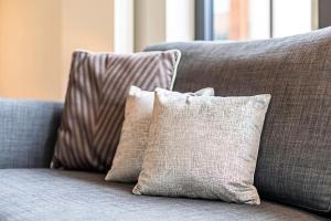 a couple of pillows sitting on a couch at Wonderful Holborn Apartment in London