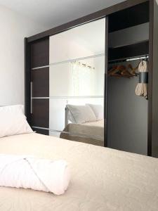 a bedroom with a large mirror and a bed at Katoikia Elia in Xirokámbion +16 photos
